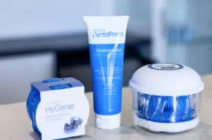 Dental hygiene products on a counter, including toothpaste and a toothbrush set.
